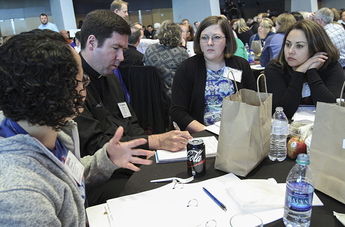 Father Joseph Shaute, second from left, pastor of St. Cement Church, Calhoun, takes notes as he receives input from his staff members (l-r) Gloria Carroll, Margaret Dutton and Oralia Gollaz during the March 14 session of the Amazing Parish Conference at the Atlanta Marriott Marquis Hotel. Photo By Michael Alexander