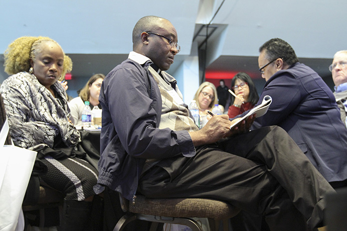 Claretian Father Paschal Amagba, pastor of Corpus Christi Church, Stone Mountain, takes notes as he sits between two of his parish leaders Winifred Vanyounga, left, and Marlene Lee-Seaton. Photo By Michael Alexander