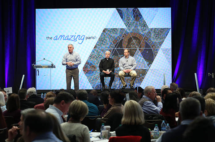 The Amazing Parish cofounder and presenter, Pat Lencioni, standing left, is joined on the stage by presenters and coauthors of the books “Rebuilt, Tools for Rebuilding, and Making Church Matter,” Father Michael White and Tom Corcoran, following a presentation on “the Sunday experience.” Photo By Michael Alexander