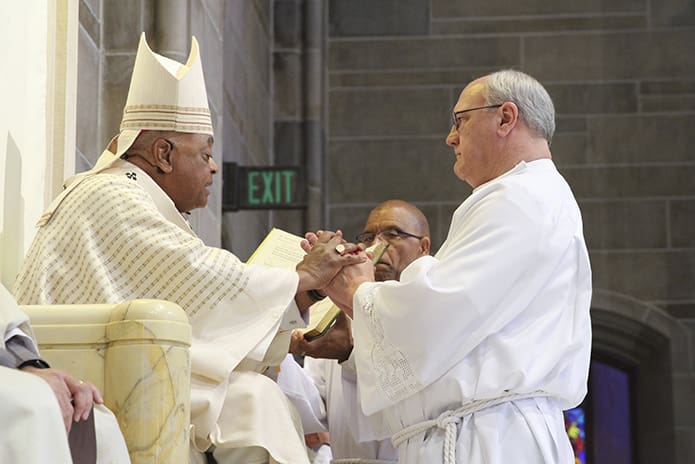 David Fragale, from Transfiguration Church, Marietta, pledges his obedience to Archbishop Wilton D. Gregory and his successors during the Feb. 3 rite of ordination to the permanent diaconate at the Cathedral of Christ the King, Atlanta. Photo By Michael Alexander