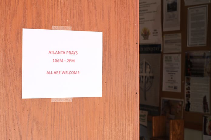A sign on the door at Our Lady of Lourdes Church, Atlanta, welcomes parishioners and visitors to stop in and pray for the city, May 8. Our Lady of Lourdes was one of three downtown host sites. The other two were Ebenezer Baptist Church and Atlanta Mission. Photo By Michael Alexander