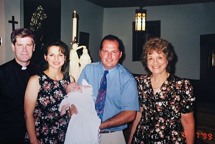 (L-r) Father Bernard E. (Ned) Shlesinger III stood in as the godfather for Janice and Wade Giddens’ second son, Cameron. Standing to the far right is Janice’s mother, Marie McKenna, the godmother. The baptism took place August 7, 1999 at Our Lady of Guadalupe Church, Newton Grove, N.C. Bishop Shlesinger and McKenna are also the godparents for Janice and Wade’s first son, James. Photo Courtesy of Wade and Janice Giddens