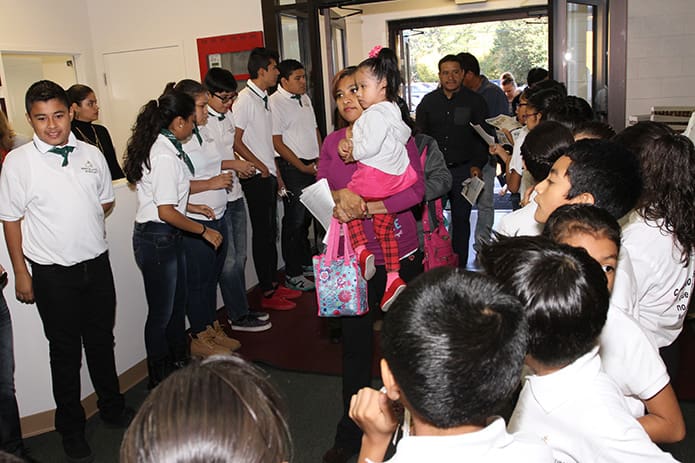 Youngsters at various levels of their religious education upbringing line the interior entrance to the mission as families enter for inaugural 9:30 a.m. Mass at the Cathedral of Christ the King Mission on Sept. 13. Photo By Michael Alexander