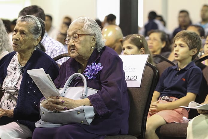 Herlinda Arevalo, 87, left, and Manuela Landivar, 93, sit during the Liturgy of the Word. The two seniors have been members of the mission for nearly 20 years. Photo By Michael Alexander