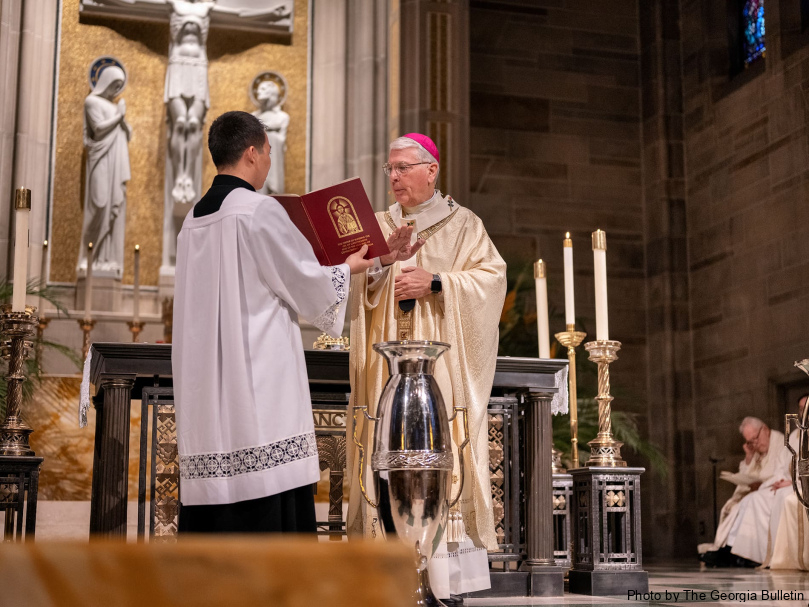 Archbishop Gregory J. Hartmayer, OFM Conv., consecrates the oil during the Chrism Mass March 26 at Cathedral of Christ the King in Atlanta. Photo by Johnathon Kelso