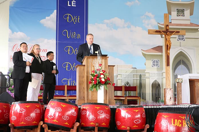 David Spotanski, chief operating officer for the Archdiocese of Atlanta, reads a proclamation from the archdiocese to the Holy Vietnamese Martyrs Church congregation as (background, l-r) building committee member Cong Chinh Nguyen, Gwinnett County District 2 Commissioner Lynette Howard and Holy Vietnamese Martyrs Church parochial vicar Father Cong Nguyen listen in. There was another proclamation read from the Gwinnett County Commissioner. Photo By Michael Alexander