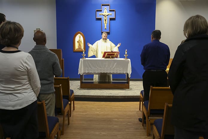 Jesuit Father Thomas Kenny is the principal celebrant during a noon Mass in the school’s Our Lady of Montserrat Chapel. Photo By Michael Alexander