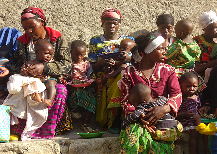 Rwandan mothers with their young children participating in a Crops for Health program in the Hyabihu District.