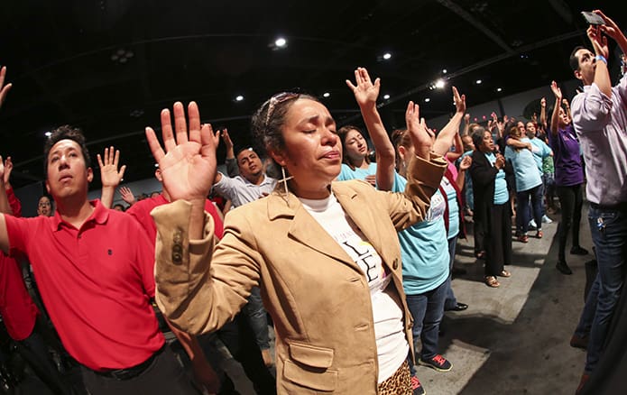 Marivel Veitran, a member of St. Joseph Church, Dalton, sheds tears of joy as the crowd in the Spanish track sings and dances to uplifting music of praise. She joined a diverse gathering of many thousands of Catholics attending the 23rd annual Eucharistic Congress, June 1-2, at the Georgia International Convention Center in College Park. Photo By Michael Alexander