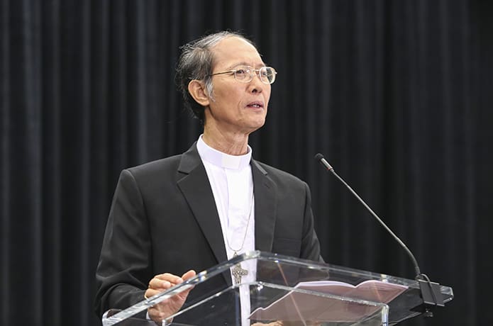 Bishop John Do Van Ngan, the auxiliary bishop of Xuân Lôc in Vietnam, conducts the second of three talks in the Vietnamese track. Photo By Michael Alexander