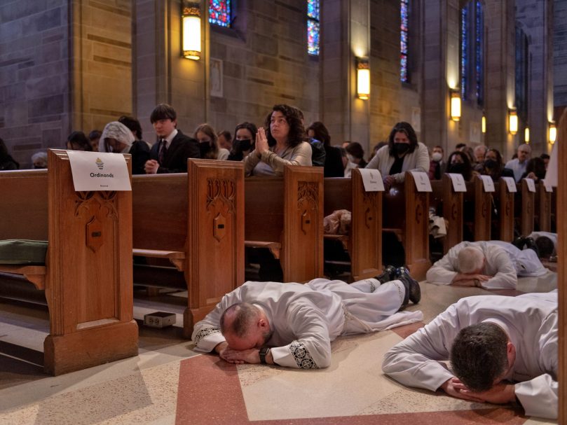 During the invitation to prayer, the permanent deacon ordination candidates lie prostrate in the center aisle at the Cathedral of Christ the King, Atlanta