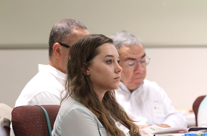 Prince of Peace Church members (clockwise from center) Ashley Estes, Bobby Armes and Leo Toledo attend the August 2 program highlighting the Catholic perspective on the death penalty. All three are members of the social action ministry at the Flowery Branch parish. Photo By Michael Alexander