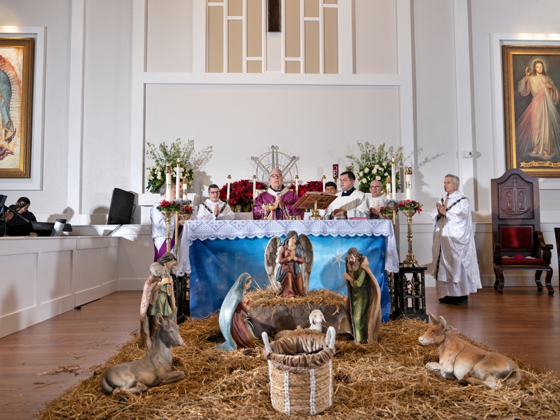 Archbishop Gregory J. Hartmayer, OFM Conv., center, prays  during the Mass and dedication service at Divine Mercy Mission. Photo by Johnathon Kelso