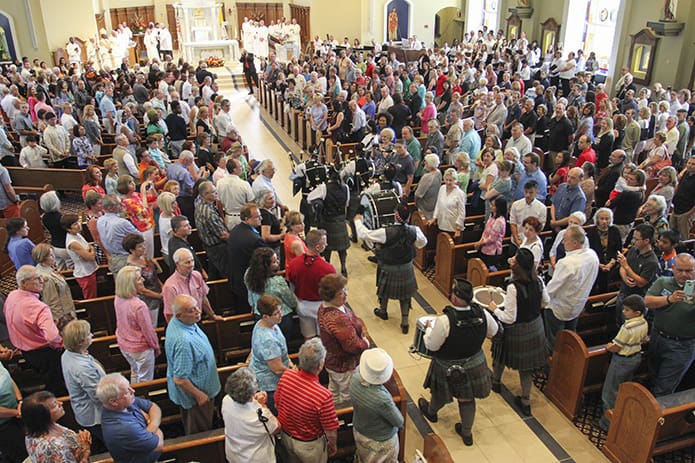 After the final blessing and before the dismissal, the North Atlanta Pipes and Drums marched up the center aisle, a surprise Father Paul Flood alluded to in his remarks. Photo By Michael Alexander