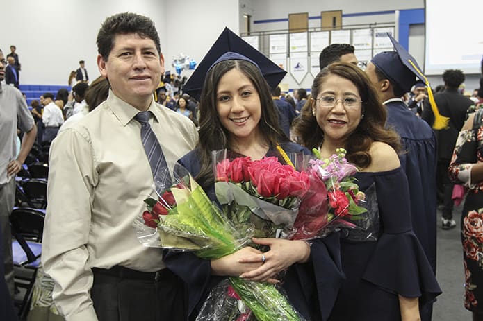 Maria Peraltilla, center, takes a post-graduation photo with her parents, Fernando, left, and Teruko. Maria is going to further her studies at Georgia State University, Atlanta. Photo By Michael Alexander