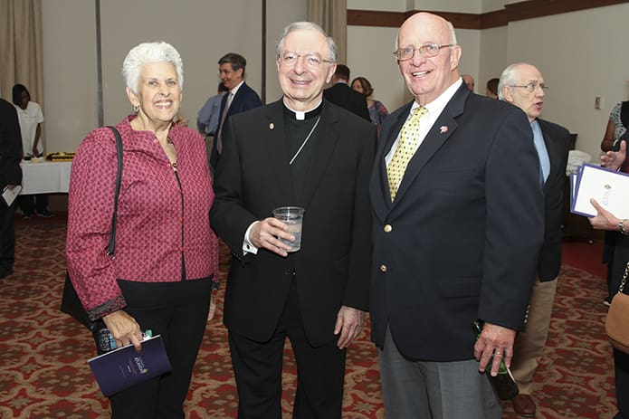 During the reception that followed the solemn vespers service, Bishop-designate Joel M. Konzen, SM, poses for photo with Katie and Bill Schmitz. For close to 20 years, Bill served as the chief financial officer at Marist School, Atlanta, when Konzen was the principal. Photo By Michael Alexander