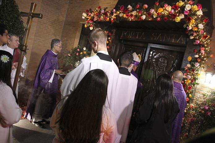 Bishop Luis Zarama opens the Holy Door at Our Lady of the Americas Mission, Lilburn, before the 7 p.m. Mass on Dec. 12. Photo By Michael Alexander