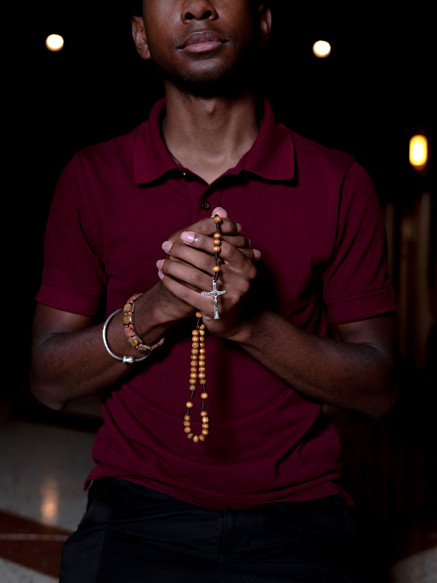 Legion of Mary member Bradley Jenkins holds a rosary while kneeling in adoration before the Blessed Sacrament at the Cathedral of Christ the King, Atlanta. He was introduced to the legion while living in Toronto. Photo by Johnathon Kelso