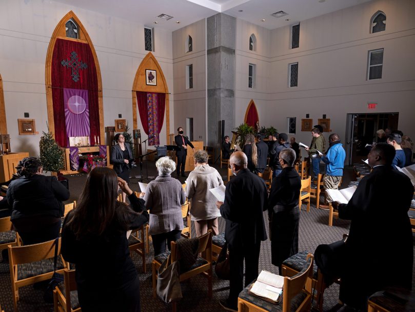 Dr. Joseph Legaspi, director of the Bowman Scholar program leads the audience in a song during the Lessons & Carols event hosted at Lyke House. Photographer, Johnathon Kelso