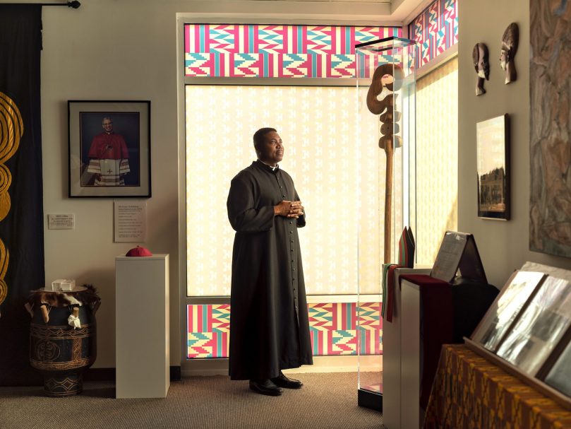 Father Urey Mark, chaplain, prays inside the Archbishop James Patterson Lyke Memorial Gallery at Lyke House. Photo by Johnathon Kelso