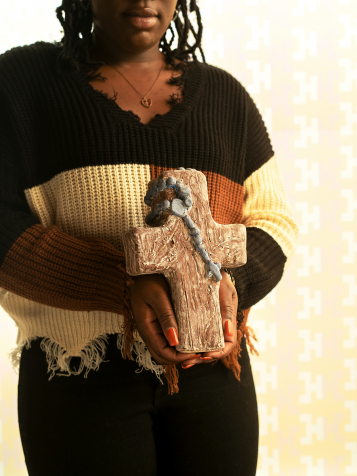 Newman Scholar of the Year Betoyah Dorzema holds her sculpture, 