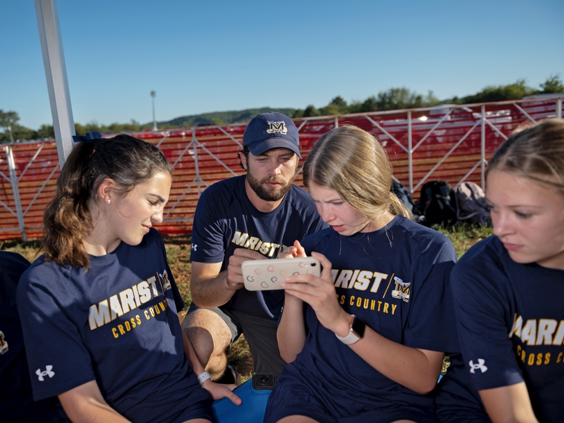 Marist Cross Country Coach Matt McMurray goes over the course with his runners before the Wingfoot XC Classic begins. Photo by Johnathon Kelso