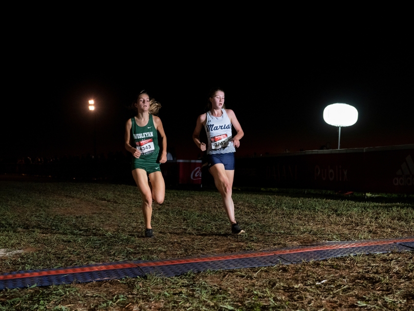 Marist country runner Ella Mullaly, right, crosses the finish line at the Wingfoot XC Classic at Sam Smith Park in Cartersville. Athletes from 150 schools competed. Photo by Johnathon Kelso