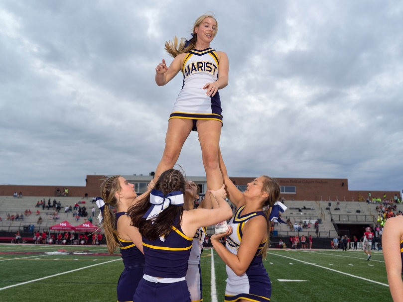 Marist varsity cheerleaders rally the fans during the game against Woodward Academy which took took place on Sept. 9. Photo by Johnathon Kelso