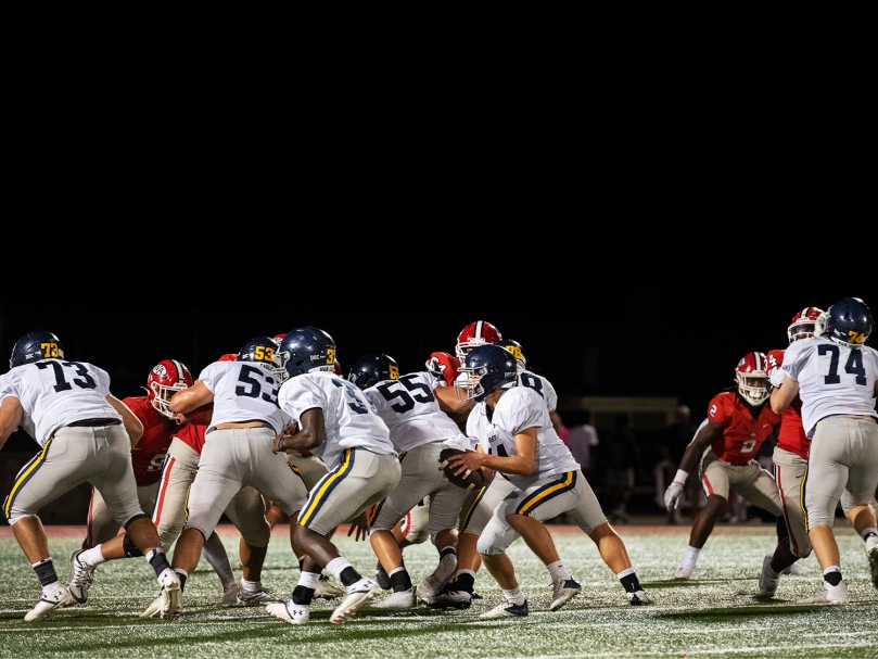 Marist quarterback Jack Euart falls back for a throw during the fourth quarter of the game against Woodward Academy. Photo by Johnathon Kelso