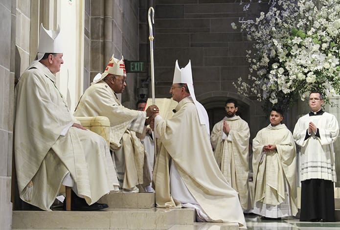 During the investiture, Archbishop Wilton D. Gregory presents the crosier, the third and final sign of the office of the bishop, to Bishop Joel M. Konzen, SM. The other two signs include the ring and miter. Photo By Michael Alexander