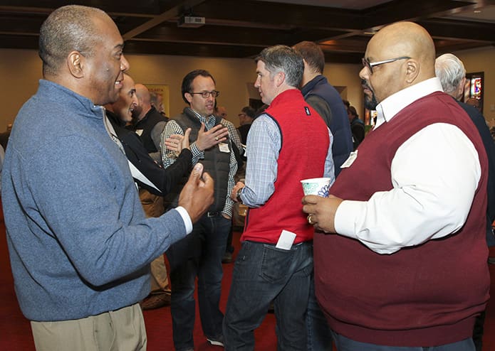 Rock Anderson, left, of St. Anthony of Padua Church, Atlanta, and Curtis Grossley of St. Philip Benizi Church, Jonesboro, converse over a break in Holy Spirit Church’s McDonough Hall. They joined hundreds of other men for the Archdiocese of Atlanta’s inaugural Men's Morning of Spirituality. Photo By Michael Alexander