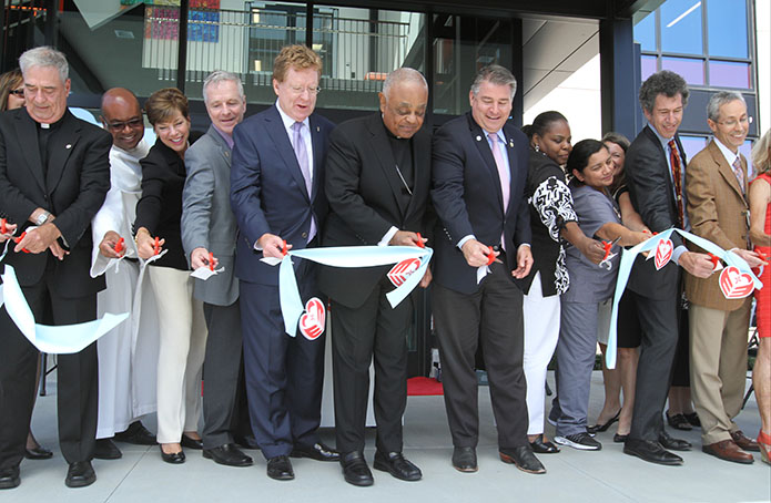 (L-r) Marist Father James Duffy, pastor of Our Lady of the Assumption Church, Atlanta, Dominican Father Jeffery Ott, pastor of Our Lady of Lourdes Church, Atlanta, Mary Ellen Garrett, board chair, Mercy Care Foundation, Tom Andrews, Mercy Care president, David Fitzgerald, board chair and capital campaign co-chair, Saint Joseph’s Health System, Archbishop Wilton D. Gregory, Mayor Eric Clarkson, city of Chamblee, Erica Stokes, vice president of finance for Mercy Care, Maria Gladys Torres, Mercy Care Chamblee staff, Bonnie Hardage, former president of the Mercy Care Foundation, Tom Davis, Mercy Care board chair, and Dr. Gabriel Onofre, Mercy Care Chamblee staff, participate in the ceremonial ribbon cutting. Photo By Michael Alexander