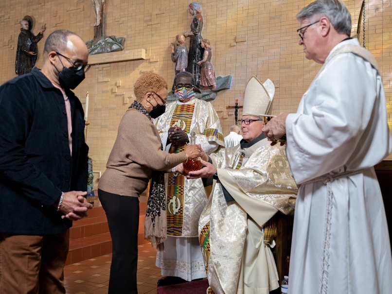 The faithful present the gifts of bread and wine to Archbishop Gregory J. Hartmayer, OFM Conv., center, during a Mass held in honor of Martin Luther King Jr. at St. Paul of the Cross Church. Photo by Johnathon Kelso