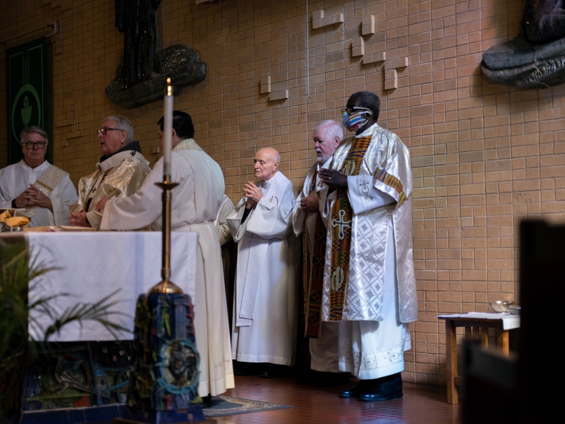 Passionist Father Jerome McKenna, pastor of St. Paul of the Cross, center, stands with the clergy during the Mass in memory of Martin Luther King Jr. Photo by Johnathon Kelso