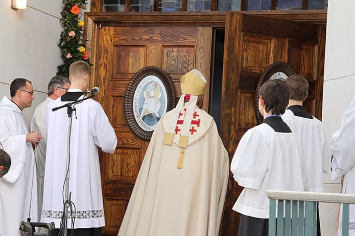 Archbishop Gregory opens the Holy Door. Photo By Michael Alexander