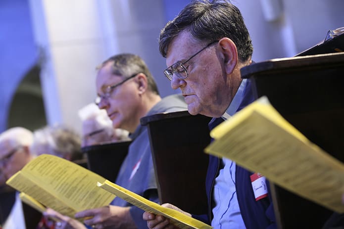 Marist Father Francis Kissell, foreground, and Conventual Franciscan Father John Koziol, background, participate in the evening liturgy of praise, the Divine Office of Vespers. Photo by Michael Alexander