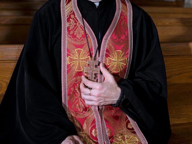 Father Volodymyr Petrytsya holds his pectoral cross at Mother of God Ukrainian Catholic Church. Photo by Johnathon Kelso