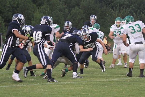 Monsignor Donovan junior linebacker Austin Johnson (#7) tackles Nathanael Greene running back Tanner Underwood for no gain. In the Aug. 23 game Johnson led the team with 19 tackles and 15 were solo. Photo By Michael Alexander