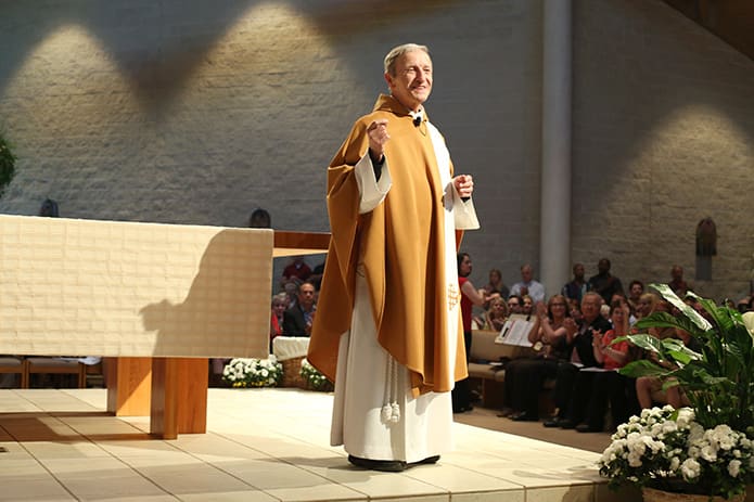 Msgr. Patrick Bishop gives some opening remarks and acknowledges special guests on hand for his May 17 retirement Mass at Church of the Transfiguration, Marietta. Photo By Michael Alexander