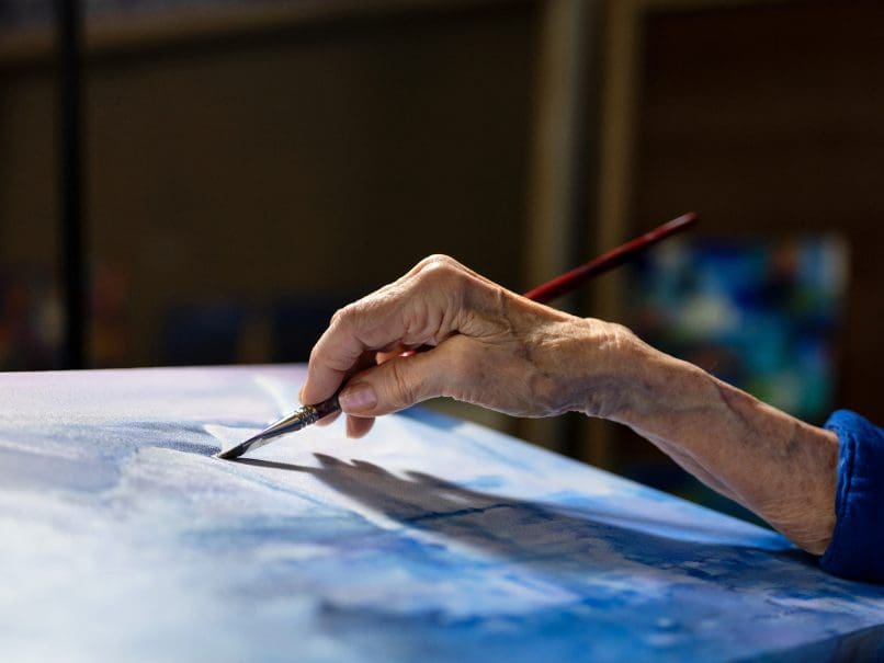 Artist Myrtha Vega paints inside her home studio. Photo by Johnathon Kelso