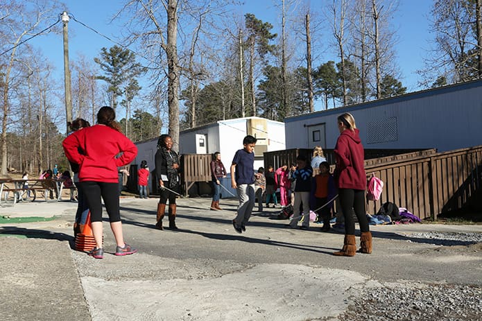 After sessions of reading, writing and penmanship, homework and other instruction, children enjoy a period of recess with the tutors. Photo By Michael Alexander