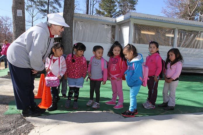 Handmaids of the Sacred Heart of Jesus Sister Margarita Martin greets the 3-year-old students arriving for the after-school program at Oasis CatÃ³lico Santa Rafaela, inside the Pinewood Estates North mobile home community, Athens. Photo By Michael Alexander