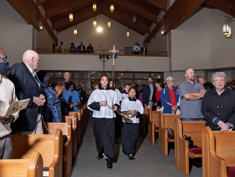 The cross-bearer and altar servers process during a a Mass held in honor of Our Lady of Guadalupe at St. Oliver Plunkett Church. Photo by Johnathon Kelso