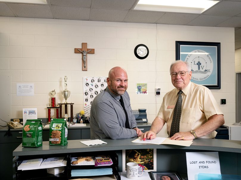 Principal George Wilkerson and substitute teacher Gordon Satkowiak work together at the office at Our Lady of Victory School. Photo by Johnathon Kelso