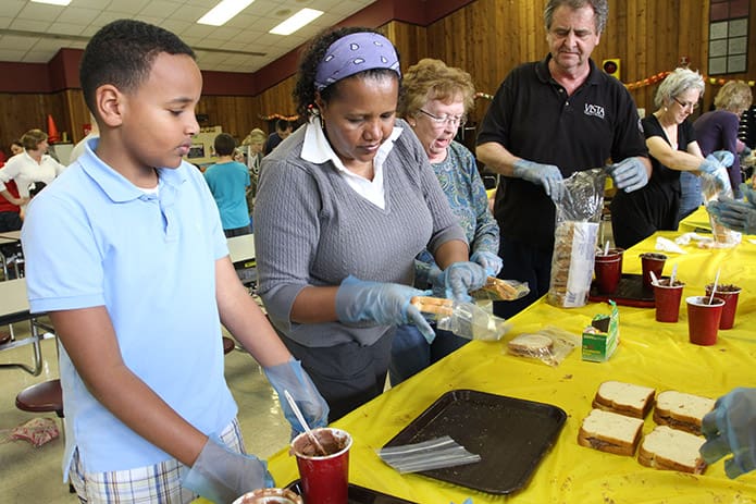 Prioritizing-charity-and-service-is-a-recommendation-under-the-key-issue-Living-Our-Faith.-Back-in-2012-nearly-200-parents-and-students-at-St.-John-Neumann-Churchâ-s-regional-school-came-together-to-make-and-pack-peanut-butter-and-jam-sandwiches-for-the-needy-at-the-Lilburn-Catholic-school.-Photo-By-Michael-Alexander