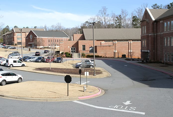 Pinecrest Academy has grown from its humble beginnings in a former Crabapple elementary school in 1993. Today as you look up the Cumming campus, foreground to background, you see the Archbishop John F. Donoghue Middle School Building, the upper school gym, the Our Lady of Guadalupe Chapel and the John and Arlene Gannon High School Building. Photo By Michael Alexander