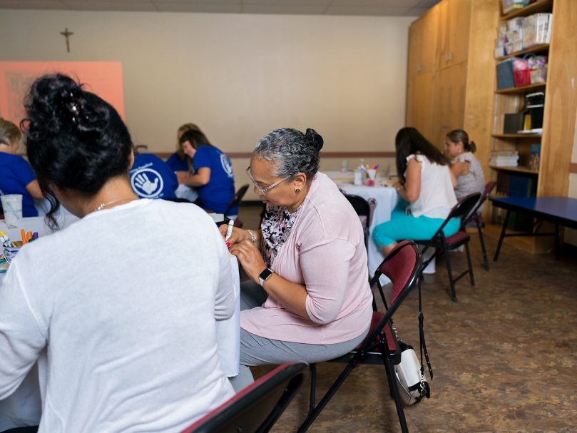 Maria Trotter, program director at St. John Neumann Preschool, takes part in a training exercise at the Preschool Summer Institute at Holy Family Church Marietta.  The day of fellowship and learning was organized by the Office of Catholic Schools of the archdiocese. Photo by Johnathon Kelso