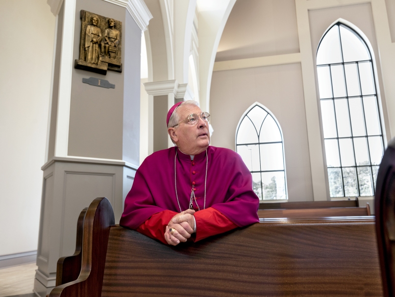 Archbishop Gregory J. Hartmayer, OFM Conv., prays in the sanctuary at Holy Vietnamese Martyrs Church before the  May 27 ordination to the priesthood. Photo by Johnathon Kelso