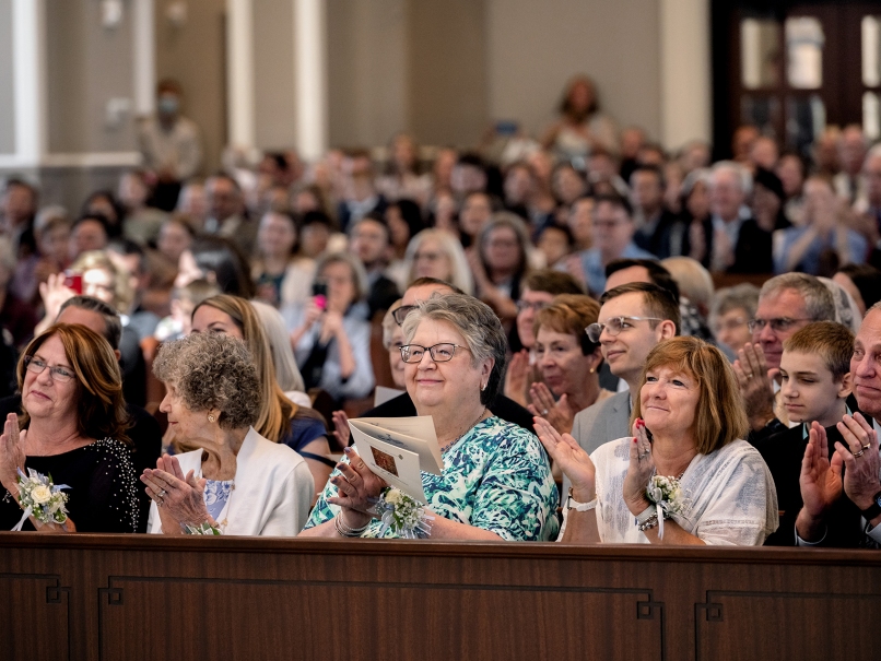 Friends and family applaud the newly ordained priests at Holy Vietnamese Martyrs Church. Photo by Johnathon Kelso