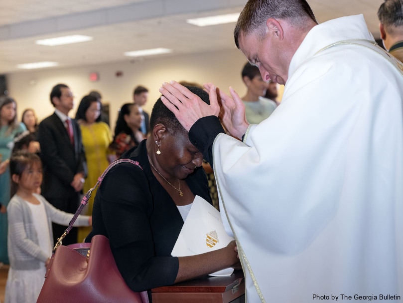 Father Colin Patrick blesses the faithful June 1 after his ordination to the priesthood by Archbishop Gregory J. Hartmayer. Photo by Johnathon Kelso